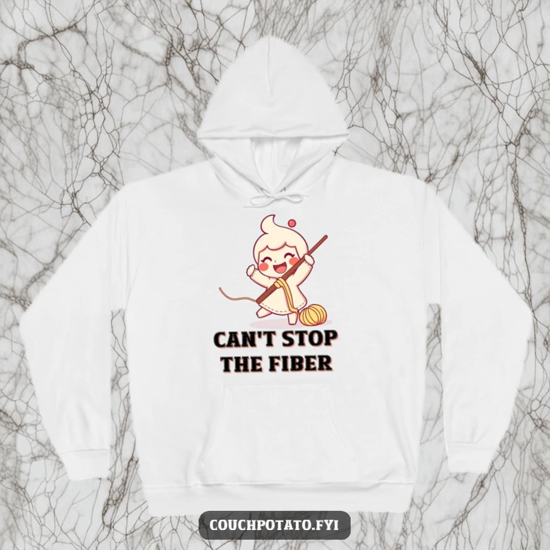 Funny smiling character swinging a large crochet hook with yarn trailing on a soft hoodie.