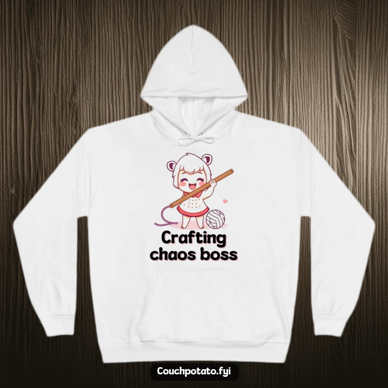 Funny hoodie design showing a smiling character wildly swinging a large crochet hook with yarn trailing, embodying crafting enthusiasm.