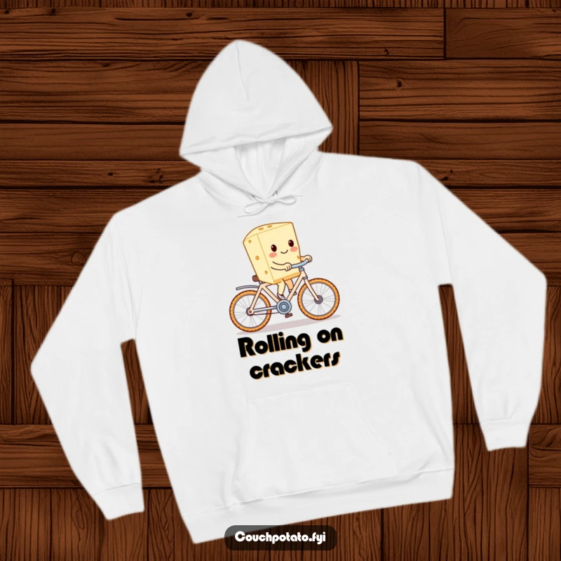 Funny cream cheese riding a cracker bike, depicted on a warm and cozy hoodie for ultimate comfort and laughs.