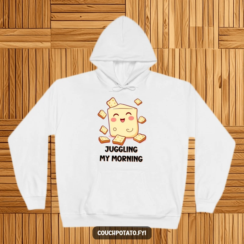 Funny hoodie featuring a winking cream cheese wedge juggling toast, offering warmth and a humorous breakfast theme.