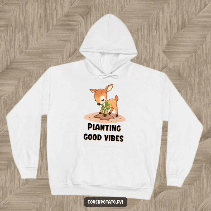 Funny deer hoodie, a playful deer gently secures soil around a young sapling, radiating a caring and humorous vibe.