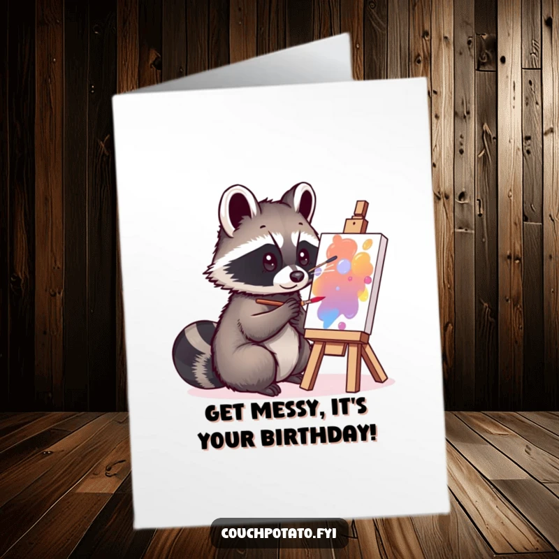 Funny Free Printable Birthday Card: A curious raccoon intently painting on a small canvas, creating a birthday masterpiece.