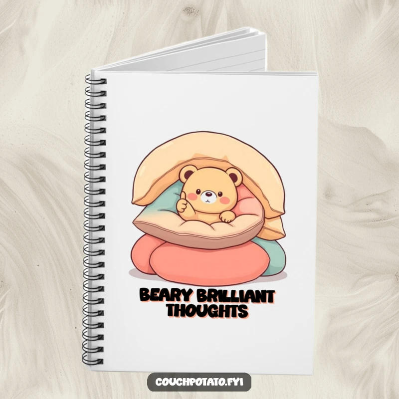 Funny round bear notebook cover featuring a small, round bear nestled in cushions, giving a thumbs up, ideal for notes and ideas.