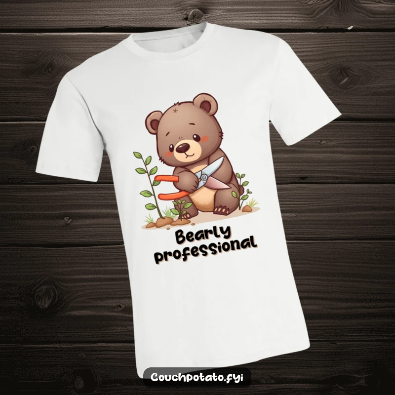 Funny bear cub t-shirt, a determined bear cub carefully prunes a tiny bush with gardening shears, showing concentration.