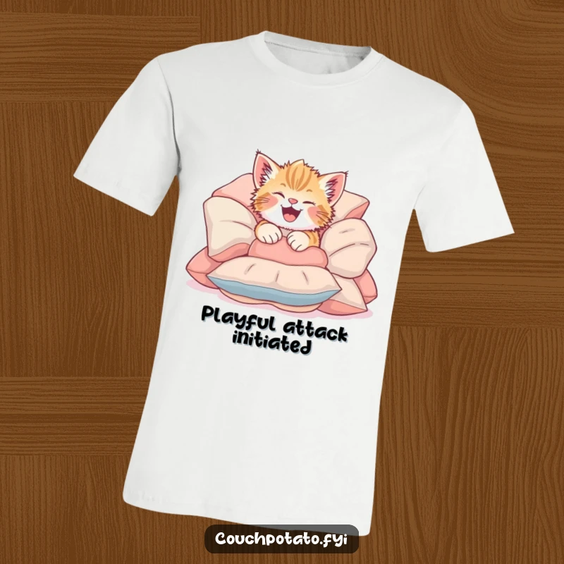 Funny Giggling Kitten T-Shirt depicting a cute kitten tumbling headfirst into soft cushions, showcasing pure, uninhibited joy.