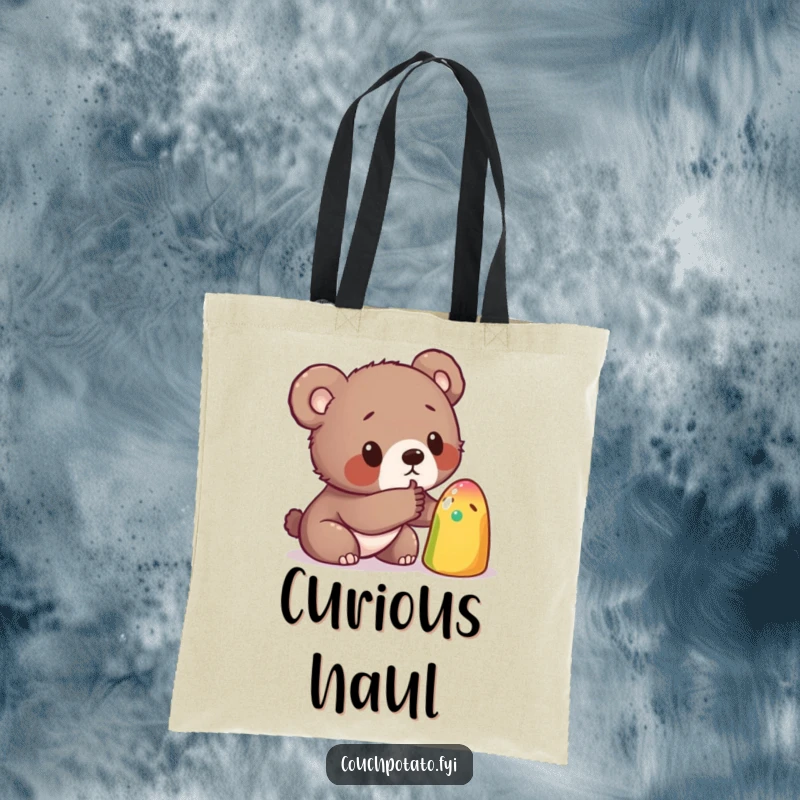 Funny tote bag illustrated with a curious bear cub poking a strange, colorful object, a delightful accessory for carrying treasures.